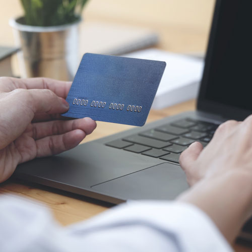 donation payment processing man entering credit card into computer
